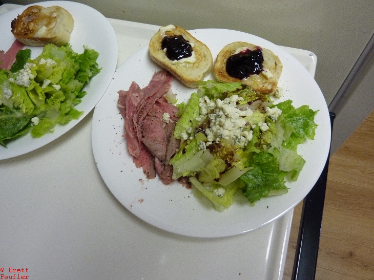 Standard meal, meat, lettuce, jellied toast on a plate, service for two, guess one of us wanted jellied toast and the other one did not, i will let you guess which was which