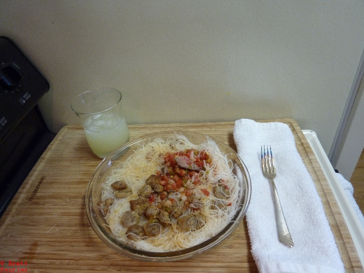 TriTip Salsa  Rice Noodles w Salsa, served with lemonaide, the hard part was figuring out where this was shot, sideways view, oven controls to the left, side of refrigerator straight ahead, a place setting for the meal, all nicely arranged on a wood cutting board, very classy, the white rags from Costco make great napkins or face cloths, pretty inexpensive, too, like 50c each, such a bargain