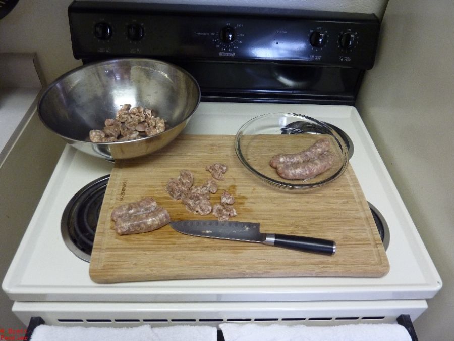 Raw sausage on cutting board with stainless steel bowl and clear pie plate