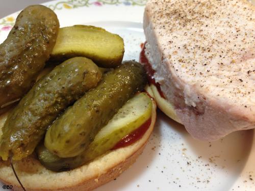 A thick slice of pork, more than an inch thick with a boatload of pickles and pool of sauce are the primary ingredients in this sandwich, because I don't fuss with the pork and reheat it in a saucer of water, the pork is plenty moist
