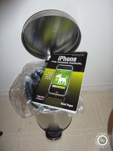 iPhone book poised over garbage can