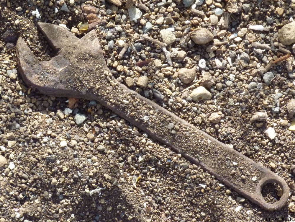 This is a dirt covered wrench in a field of dirt, or in the dirt, it caught my eye, and what catches my eye is often turned into a photograph, what is perhaps more marvellous is that this particular picture has been waiting in the wings for five odd years before it found its home here... the connection to the text is in we are doing work here, outlining the page, structural construction, this section being a means, to the end, which are the following entries