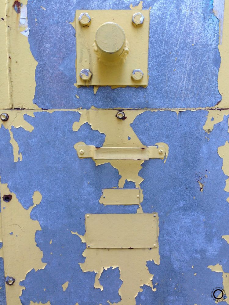 Peeling paint off of a mechanical equipment box face, I am pretty sure, as I never remember this long after the fact, that the pretty blue color is just a photographic chromatic distortion of the raw sheet steel