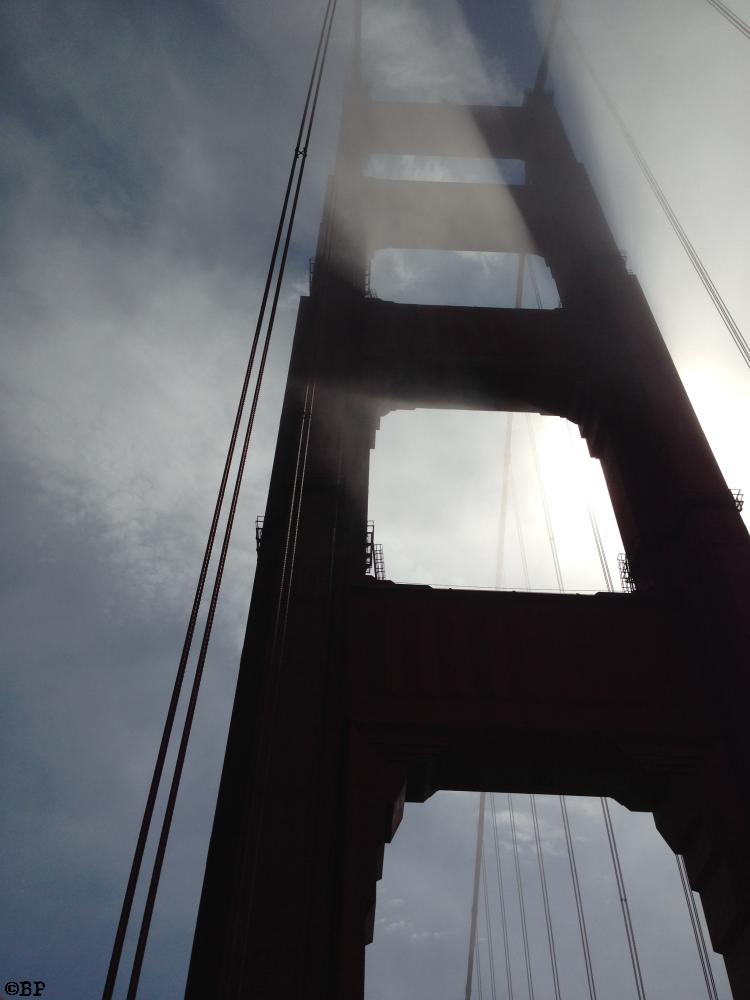 The view from the foot of a suspension tower on The Golden Gate Bridge, looking up into the fog, the sun casting shadows, um, this is not Hawaii, either, just saying