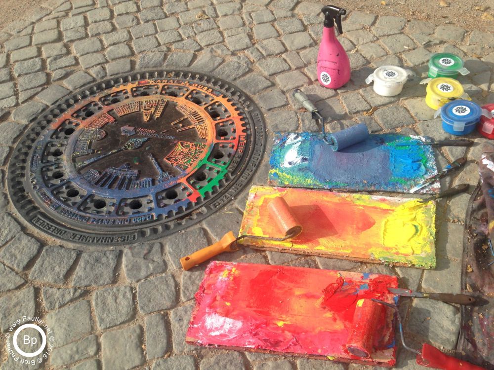 Set up for street art, down near the dome in Berlin, street artists were rolling paint over this manhole cover and then lay a white t-shirt, or other colored t-shirt over it, and press down, designed the shirt with the imprint from the manhole cover.  I did not buy a t-shirt, I did take a picture, if more folks were like me, i guess they would not spend their days vandalizing that manhole cover, so, me, a force for good