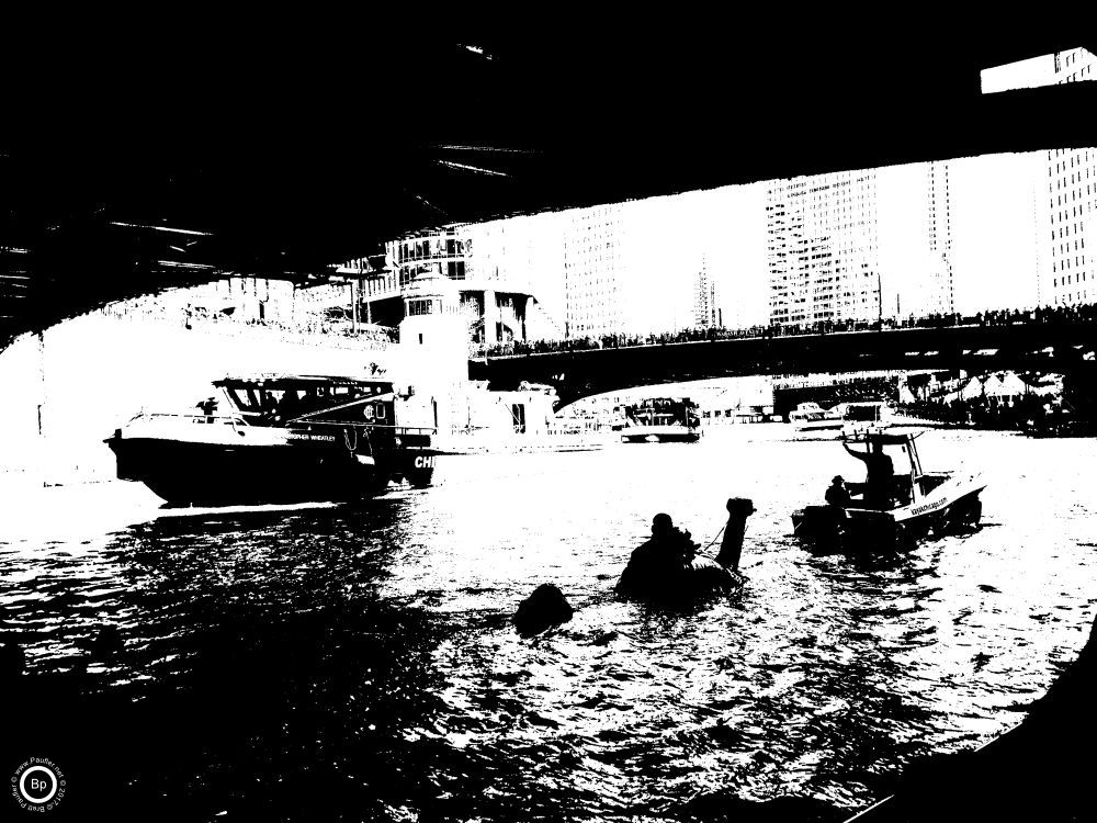 These are black and white filtered images of the green river, I sort of like the symbollism, and then, I wanted to scrub any identifying features from the images, others faces, the first is of a fire boat, going under a bridge, while another boat goes in the opposite direction, towing a Nellie, the Loch Ness Monster, float