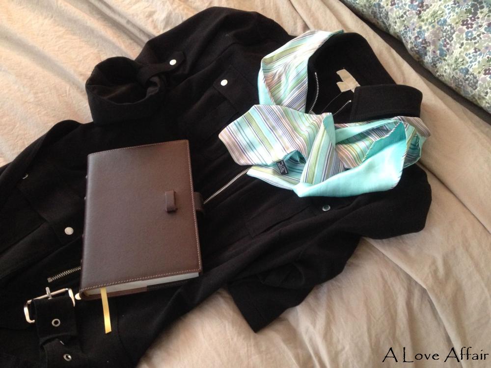 Here, we have one of those infamous black dresses, complete with belt, snaps, and zippers, accompanied by a nice blue-green scarf and leather bound jounal.  Hmm, that journal just might be important.