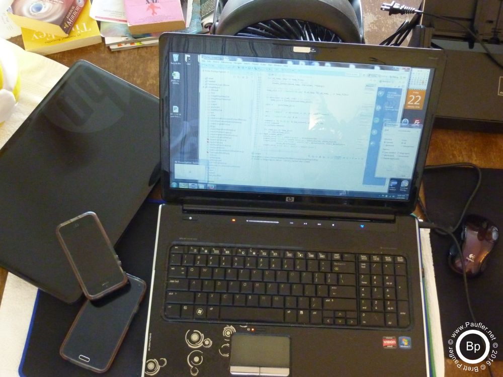 my screens, two laptops, a few phones, a fan in back to keep it all cool, with a scanner to the side.