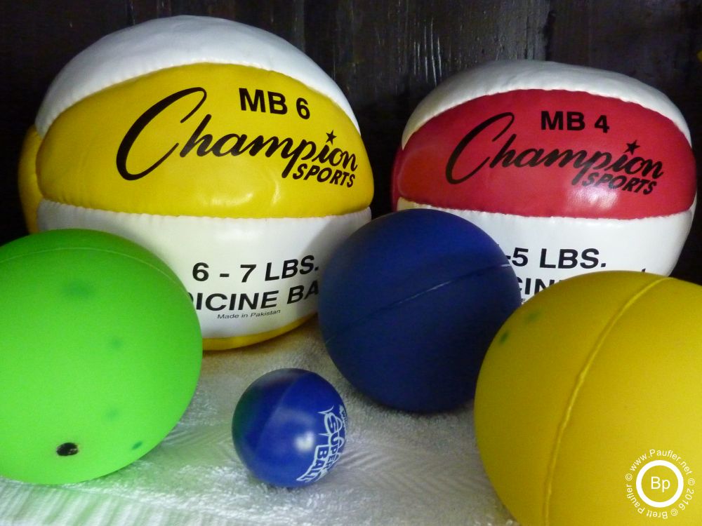 a select grouping of medicine balls, weighted soft indoor shotputs, and a rubber bouncy ball of the type super, these would be a bunch of play ball, toys