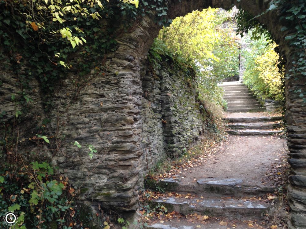 this looks through an arch, up a staircase, wide dirt path, very pleasing