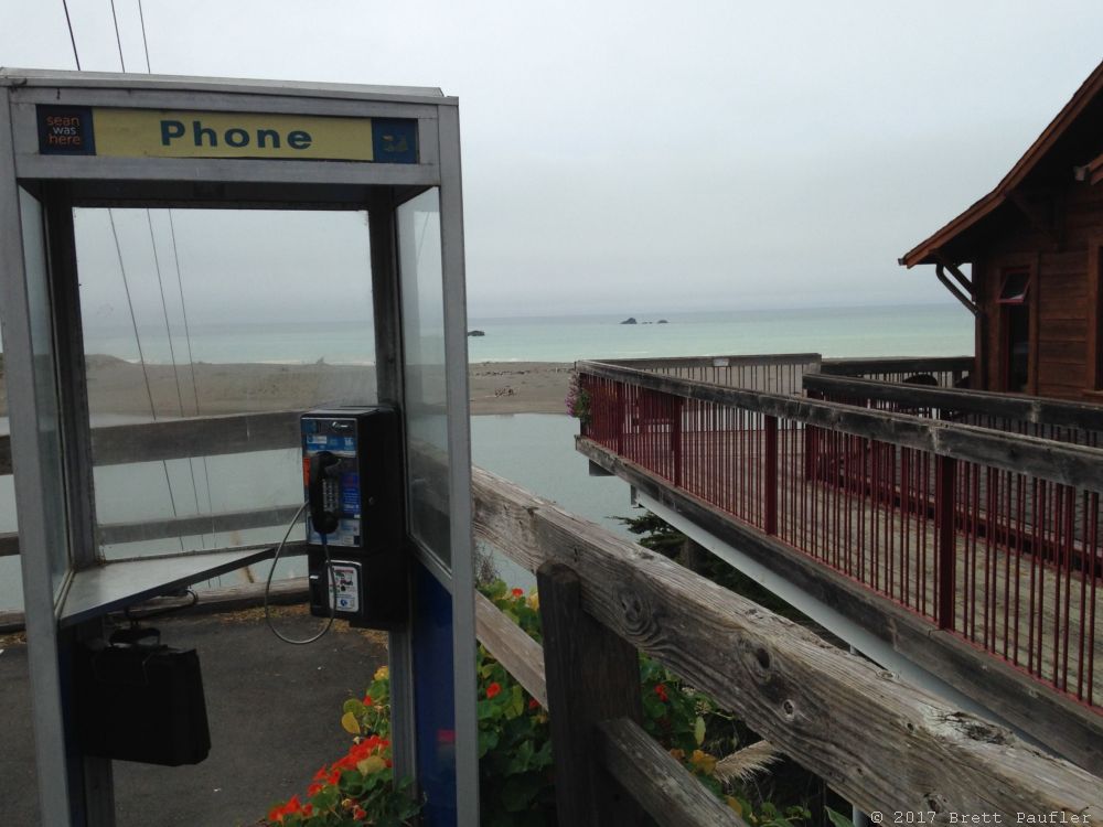 Where was this, somewhere on the West Coast, up aways from Frisco, down a ways from the Oregon border, where a river meets the sea, the perfect place to put a phone booth, I guess folks had reason to congregate there
