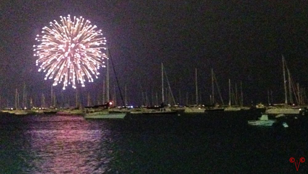 looking over the marina at the fireworks in the distance, boats in the foreground, a sparkly fire-burst, it was not a very good view and next year, if there is a next year, if next year lands me in the same place, I will view from a different location and/or angle