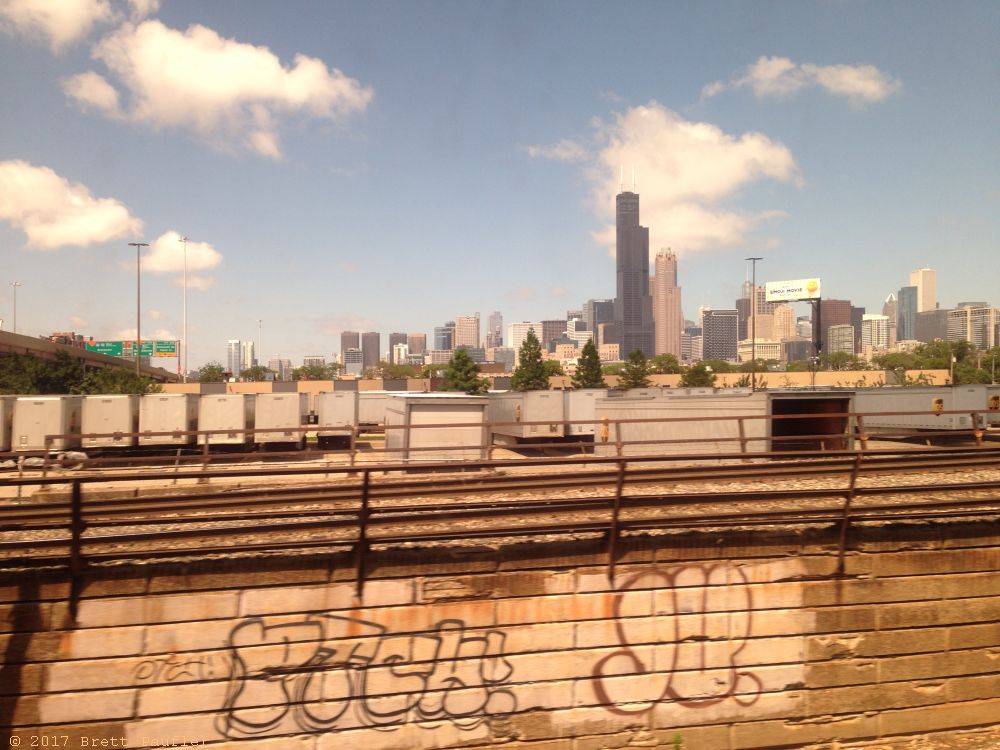 Graffiti in the foreground, the Chicago Skyline in the backgroun, I like the image, clouds are scattered across an otherwise blue sky, smooth sailing ahead