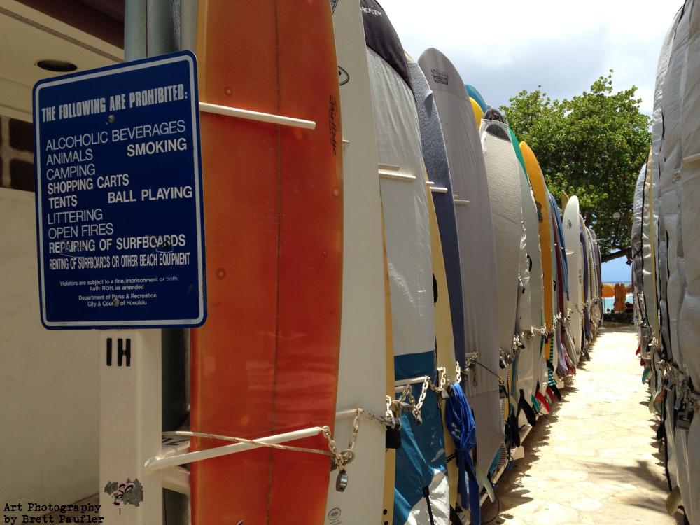 Surf Boards on the Beach at Waikiki, these are where the boards are stored, I think a person rents a spot, they are like bike racks, with the surfboards standing on edge, one after the next, looking down a row
