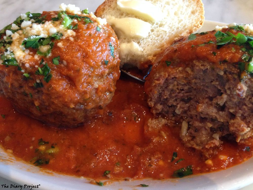 The meatballs were first class... or close enough, breaded, so not a meat lovers dream, but tasty enough that I could see going back for them, if not across town, image shows two meatballs and buttered bread wedged between them in the background
