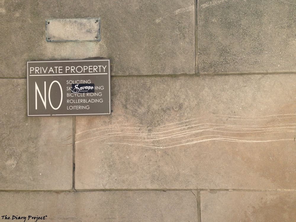 an image which has nothing to do with the text, a wall, a silly sign listing out things not to be done, and someone plastered over the no skateboarding part with a skateboarding brand sticker, classic, I think the image looks nice, pleasing, self contained, safe