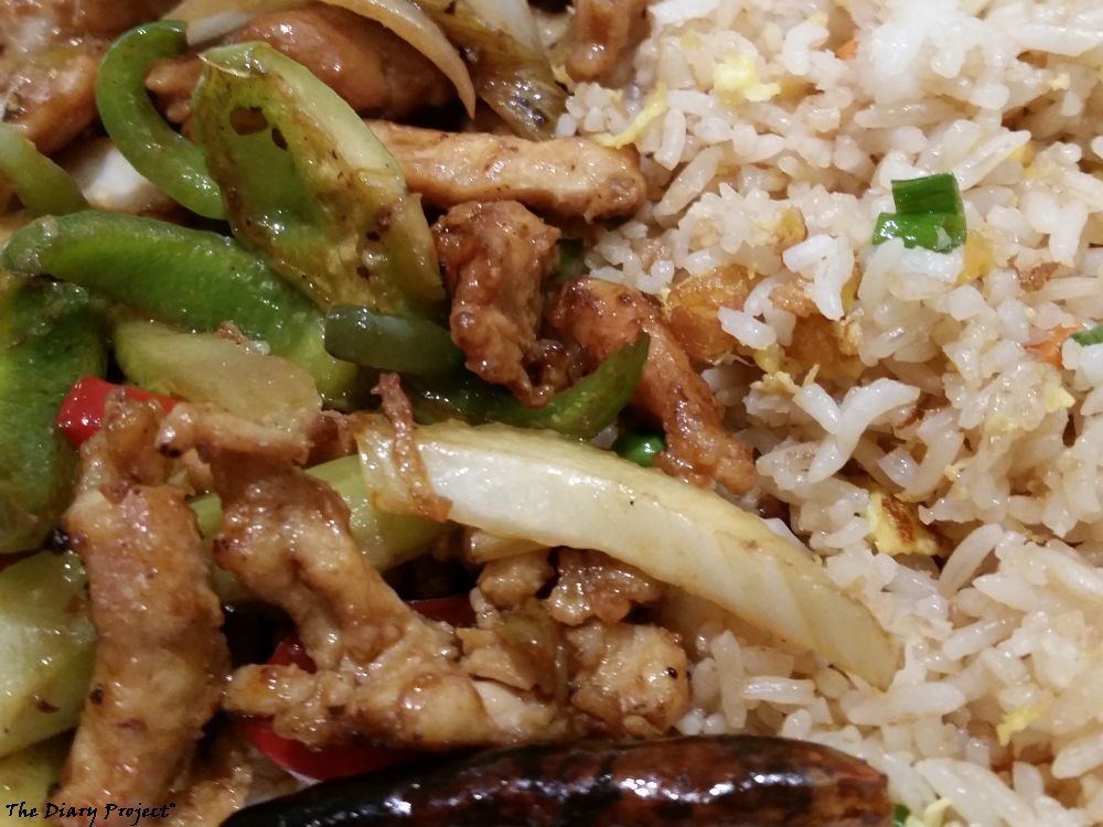 standard plate lunch, fried rice on right, two types of chicken on left, tasty, a good meal, fried beef, not shown