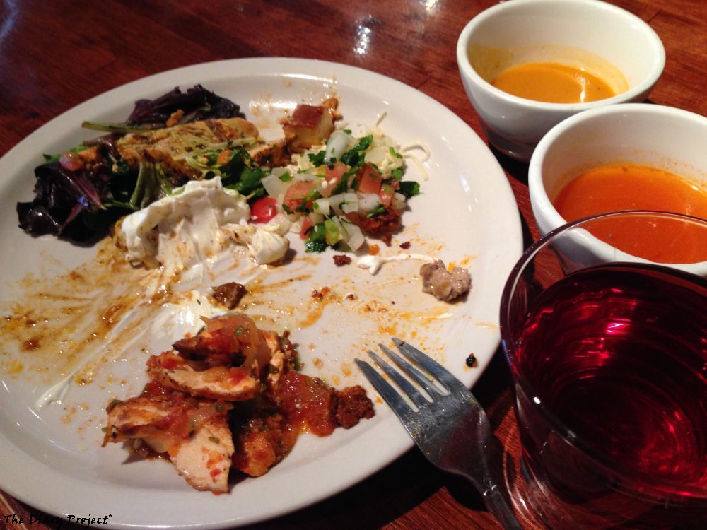 Oddly, the fajitas are not shownm, this is a half finished plate, chicken spicy, salad, salsa, sour cream, two types of soup, and cranberry juice, a nice topping on the mexican fajita plate