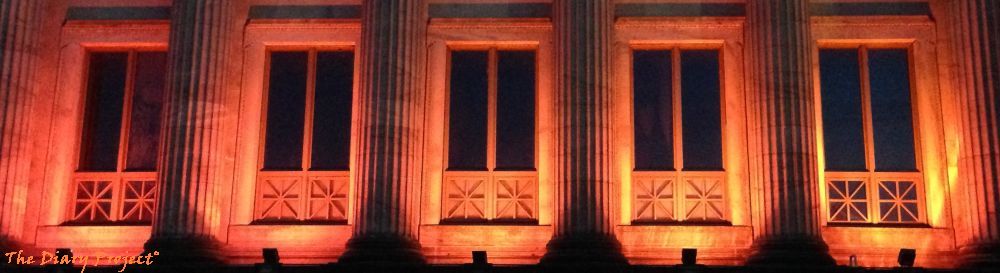 Old time greek or roman columns lit by orange and red lights, nightime delight, very regal... or spooky