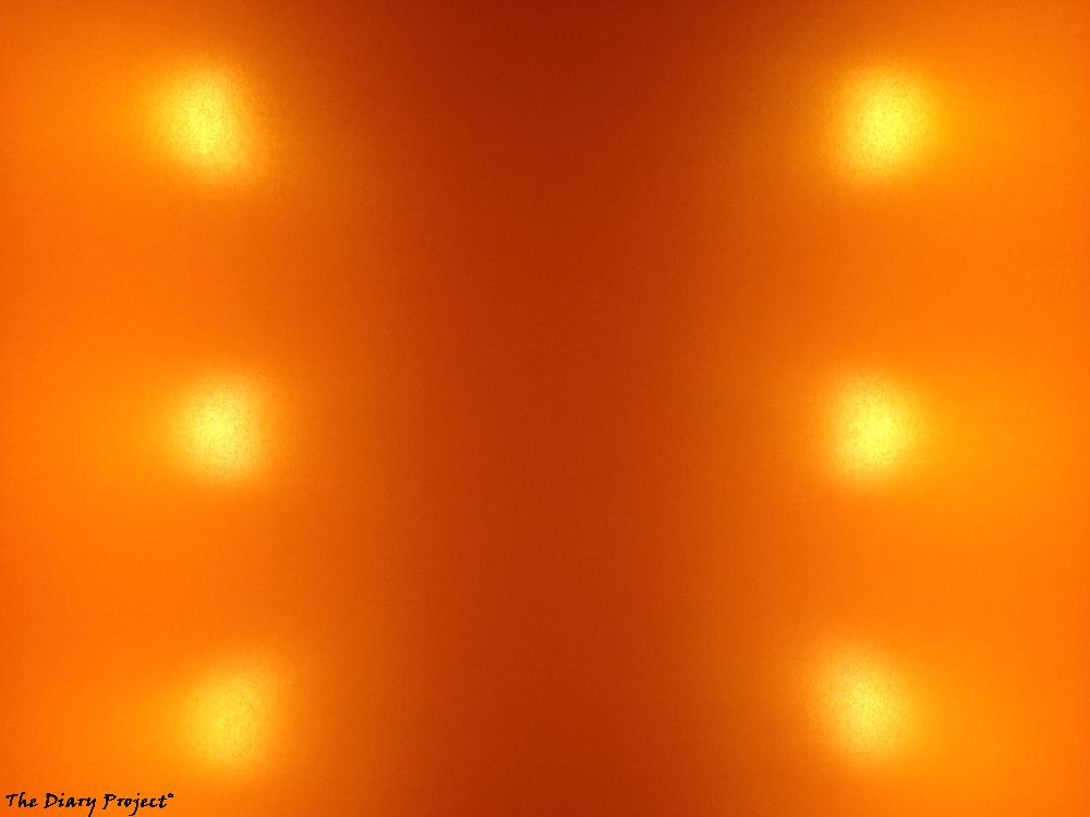 interior design, art decor, the lampshade at a restaurant, six bulbs glowing behind orange fabric