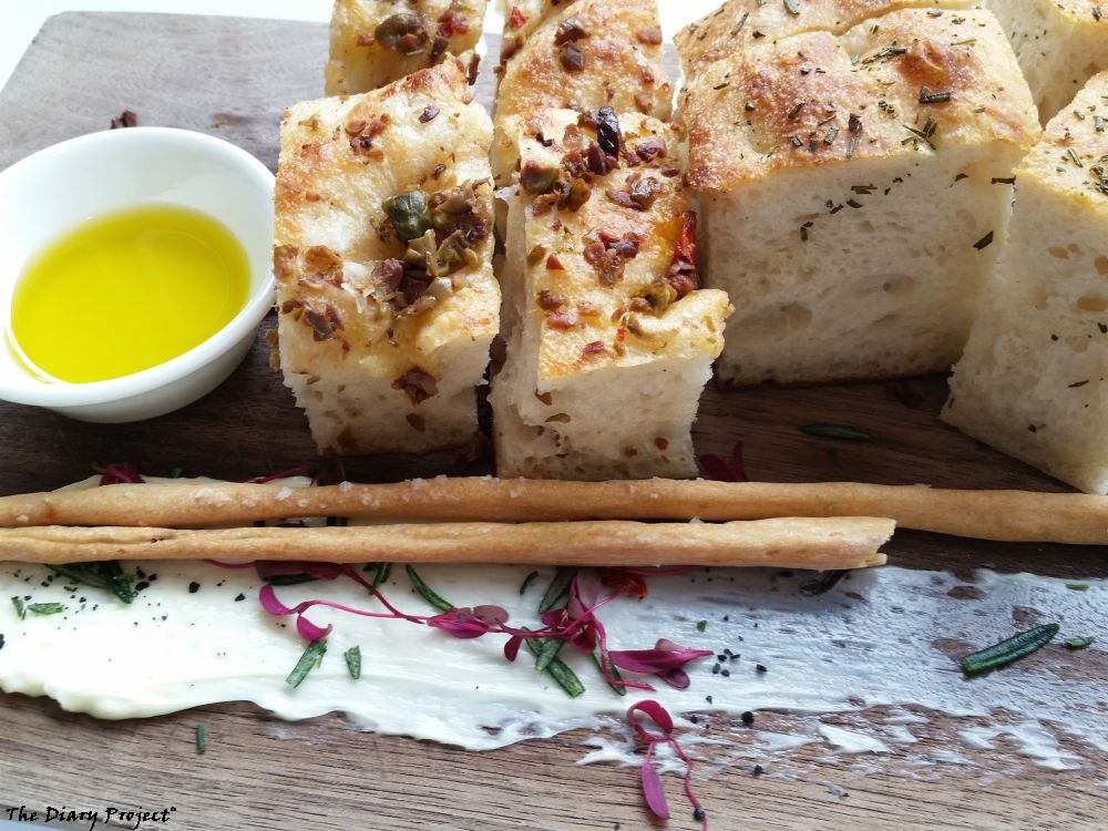 The bread plate, very nice, light foccassia, well, heavy, olive oily, tasty, olives on top, very nicely presented, have no idea if this was included or a side, you are probably looking at ten dollars worth of bread there