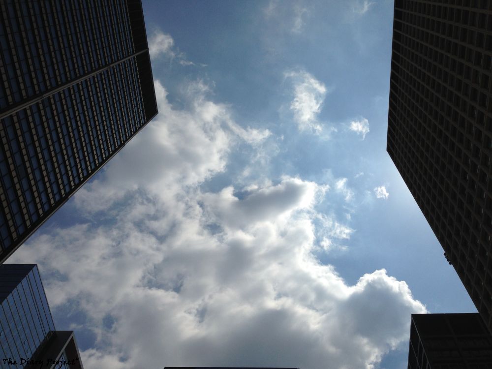 A glorious day, the blue sky as seen from betwixt skyscrapers, looking straight up