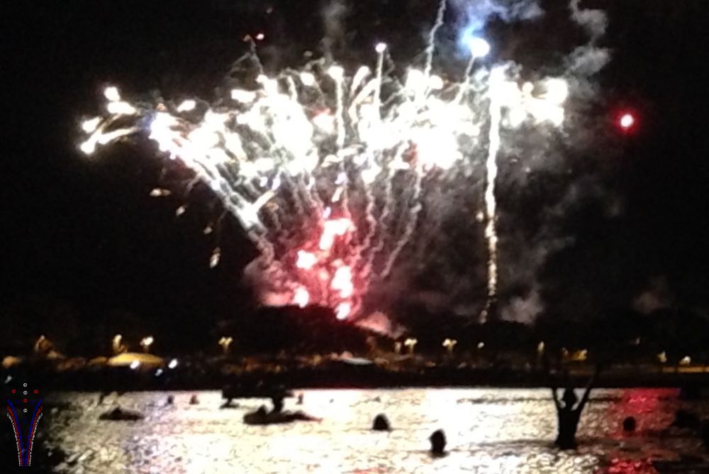 this is the view from the beach, so setting the scene, kids in water in foreground, fireworks in sky behind, it really is a nice view, one has to imagine the thrill of youth, no only swimming, but fireworks... and maybe a shark or two in the water to add some excitement