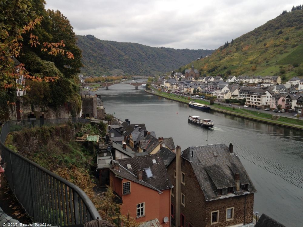 Here we have a view of a river, boat going down the middle, quaint houses on either side, looks very pretty