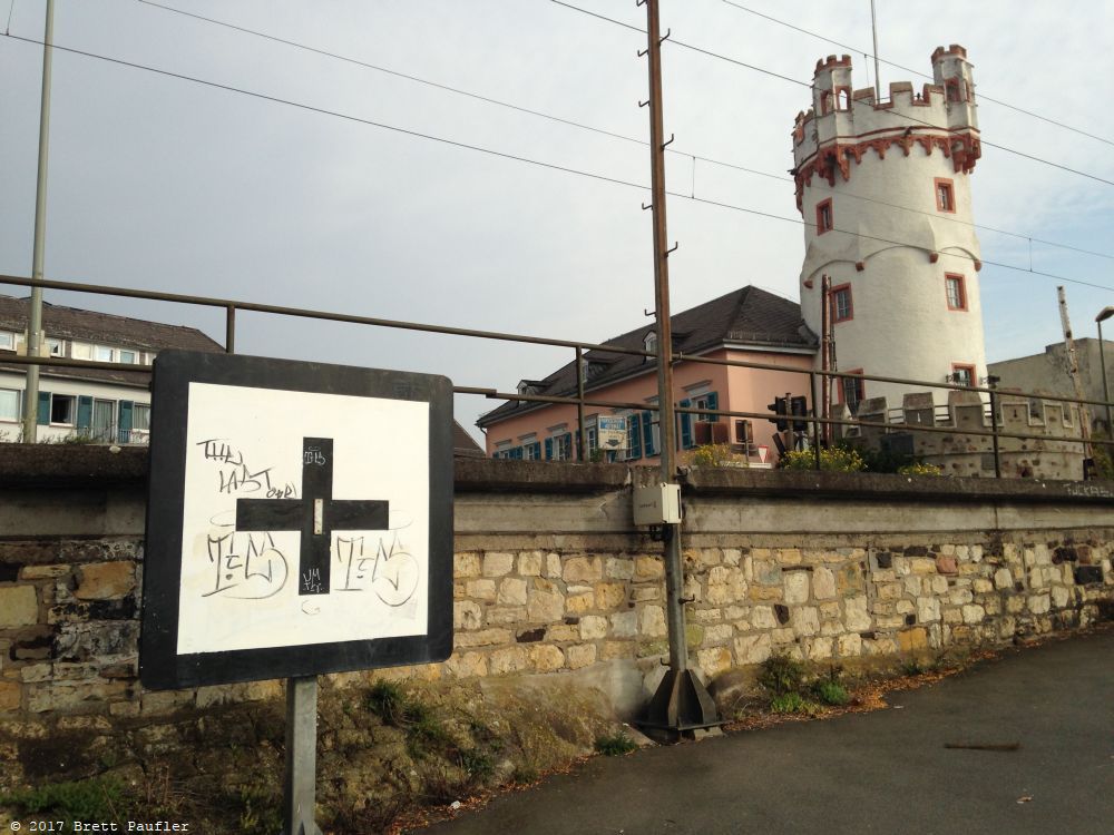 A castle by the side of the road, castle is the wrong word, a tower, who kows how old, turned into some sort of business, and the train passing right by, no train in this image